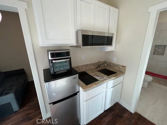 a kitchen with a stove microwave and sink