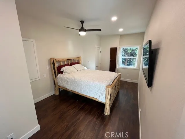 a bed room with a bed window and a television