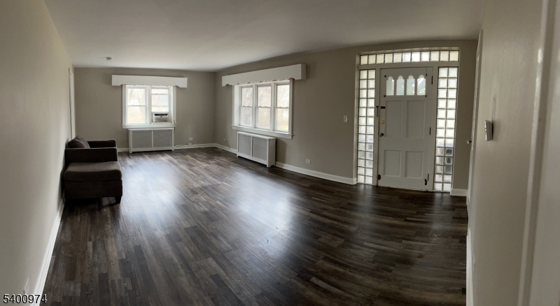 76 Ridge Road, Unit 2 Oak Ridge, NJ 07438 - Photo 4 of 12 an empty room with wooden floor and windows