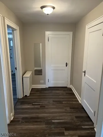 a view of a room with wooden floor and white doors