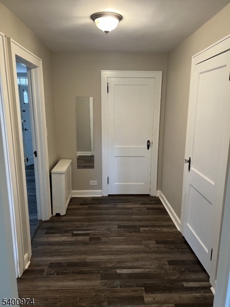 76 Ridge Road, Unit 2 Oak Ridge, NJ 07438 - Photo 7 of 12 a view of a room with wooden floor and white doors