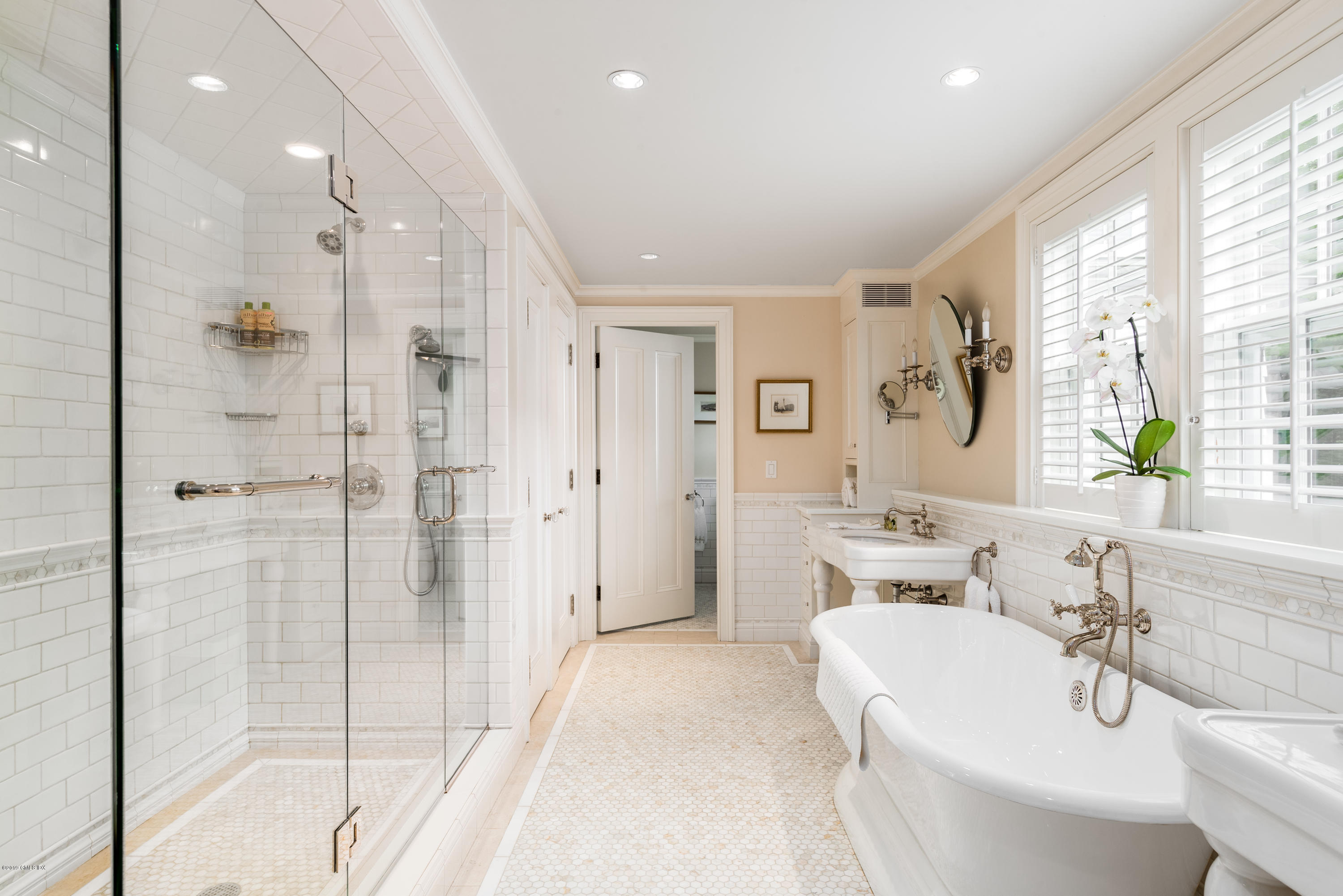 68 Doubling Road Greenwich, CT 06830 - Photo 17 of 40 a spacious bathroom with a double vanity sink a large mirror and shower