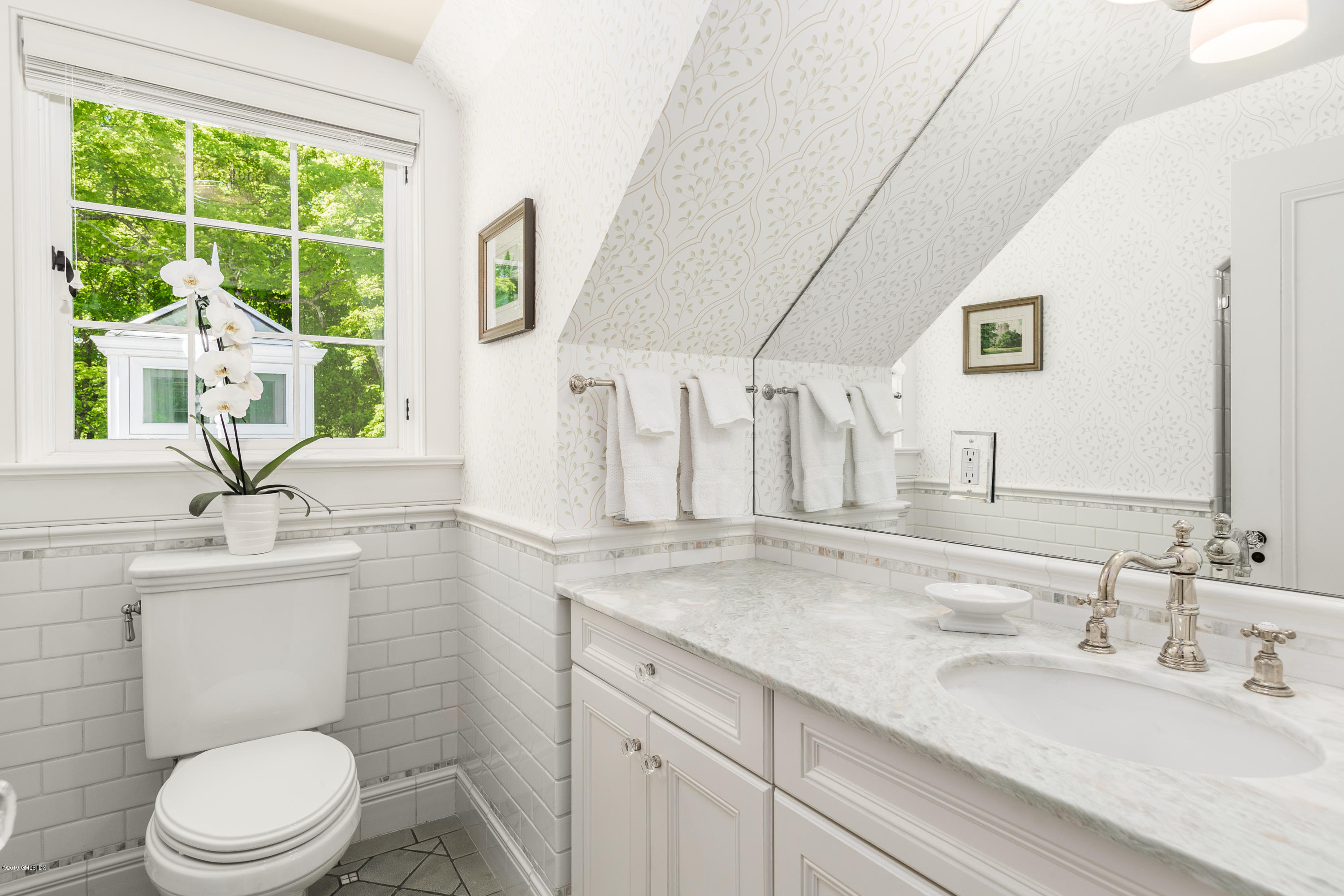 68 Doubling Road Greenwich, CT 06830 - Photo 23 of 40 a bathroom with a toilet a sink a mirror and a window