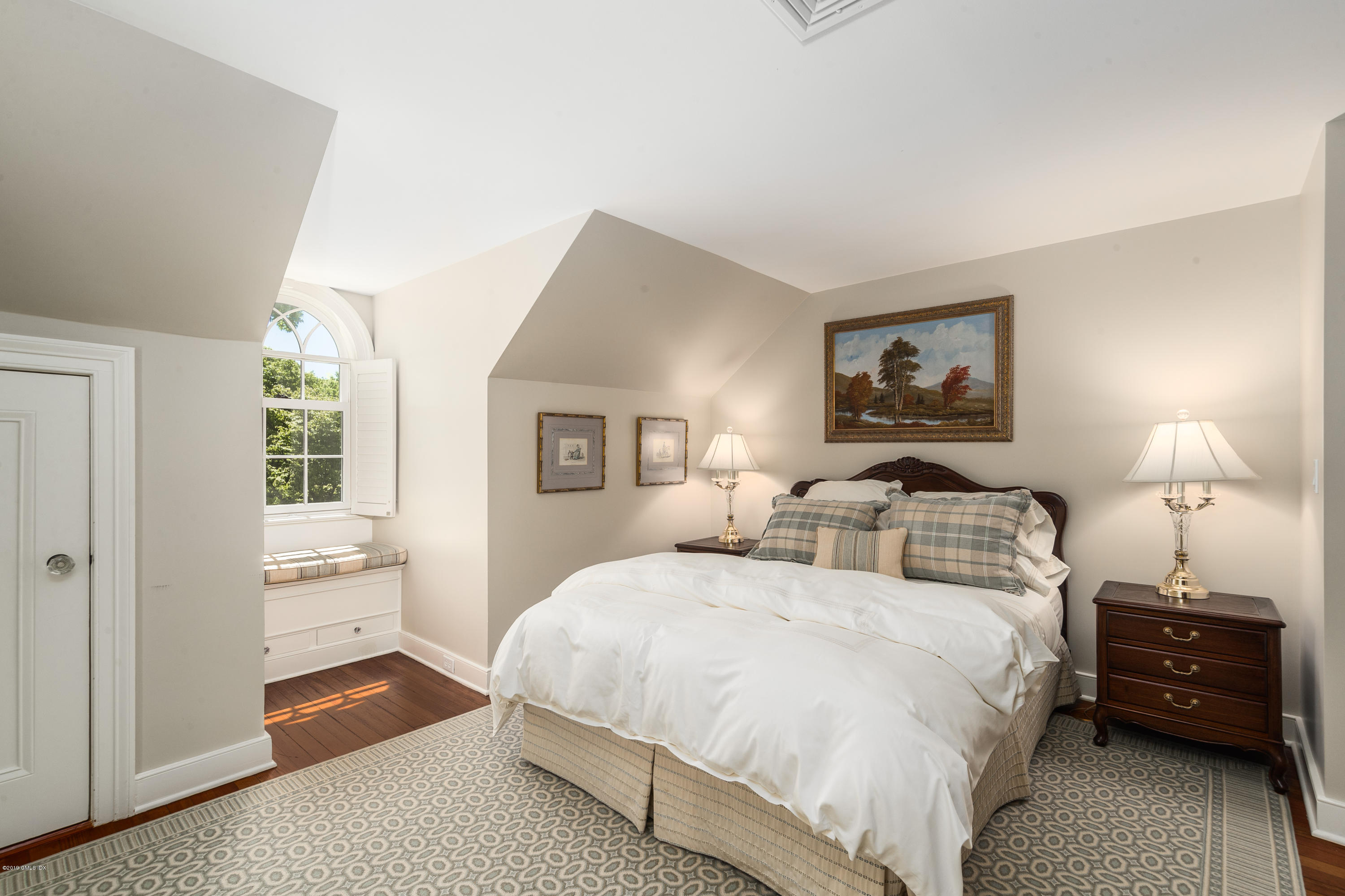 68 Doubling Road Greenwich, CT 06830 - Photo 24 of 40 a bedroom with a bed and a night lamp