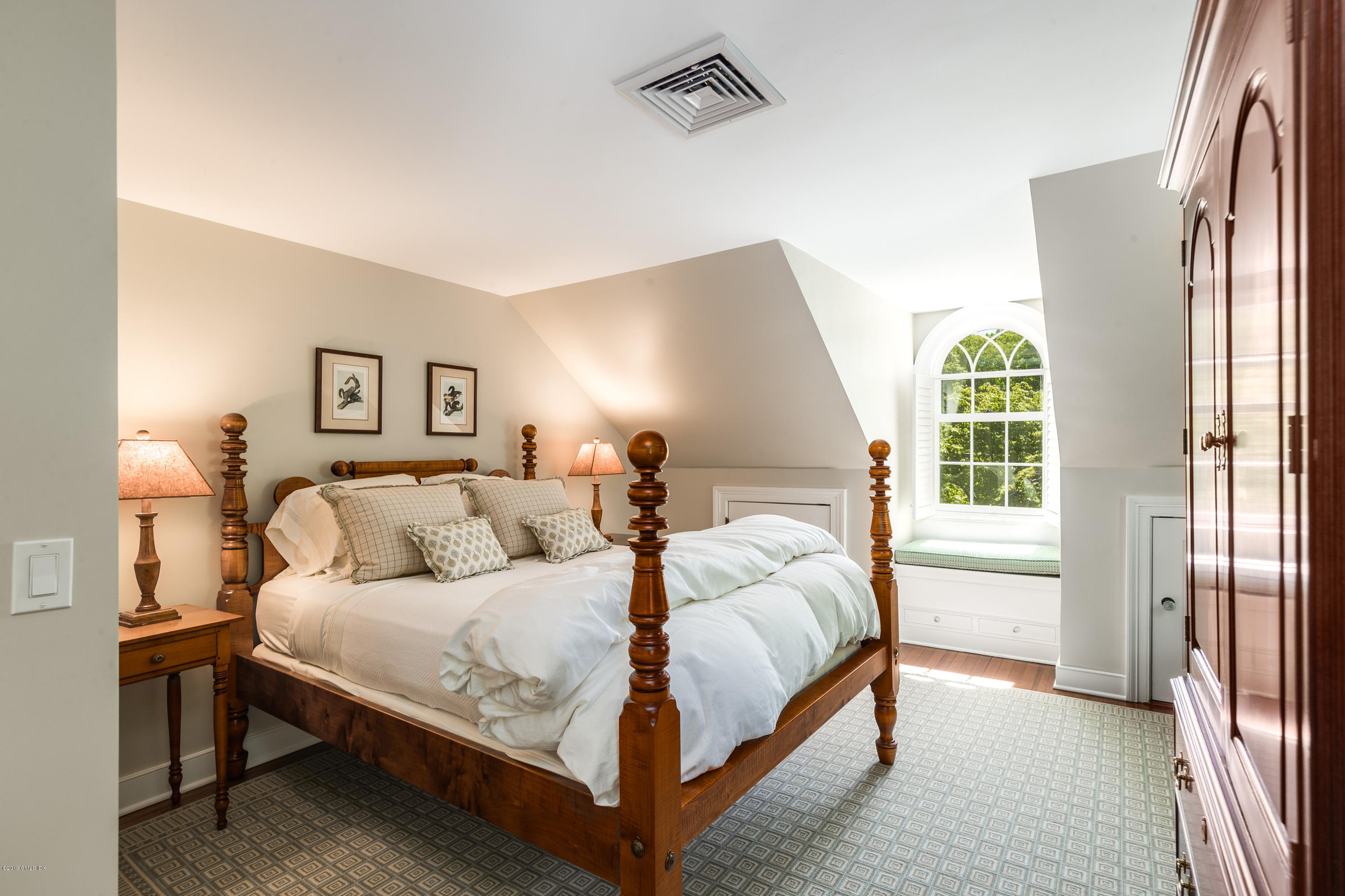 68 Doubling Road Greenwich, CT 06830 - Photo 26 of 40 a bedroom with a bed lamp and a large window