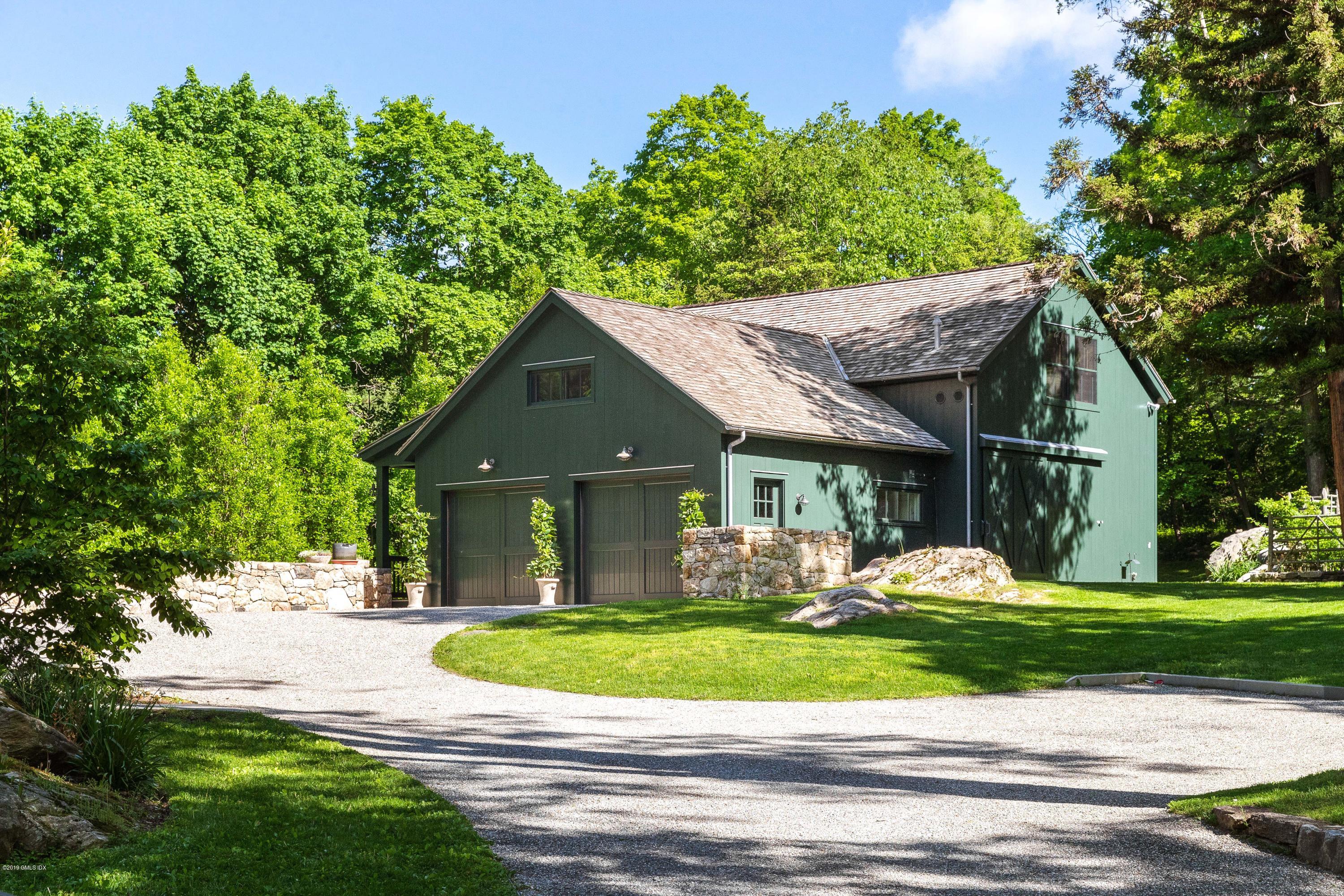 68 Doubling Road Greenwich, CT 06830 - Photo 27 of 40 a front view of a house with a yard