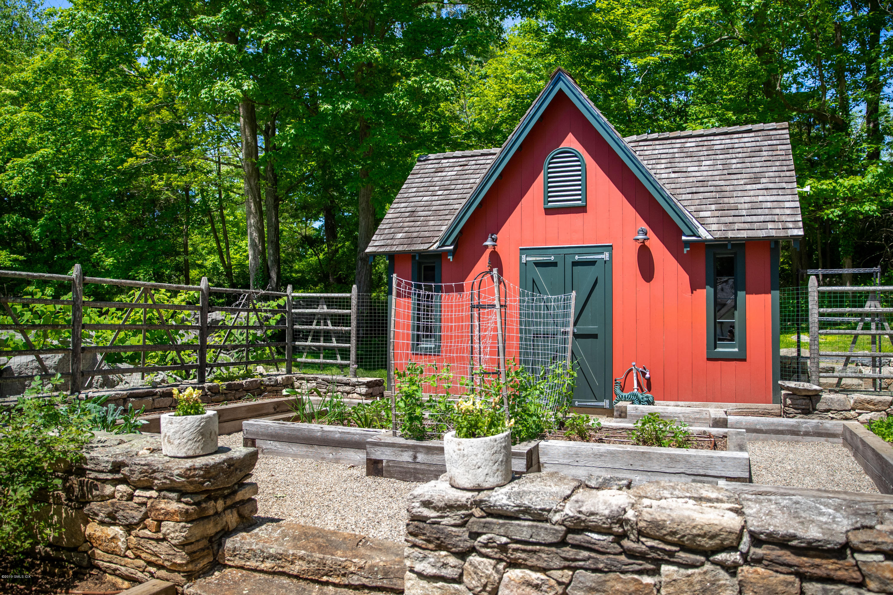 68 Doubling Road Greenwich, CT 06830 - Photo 35 of 40 a front view of a house with a yard and potted plants