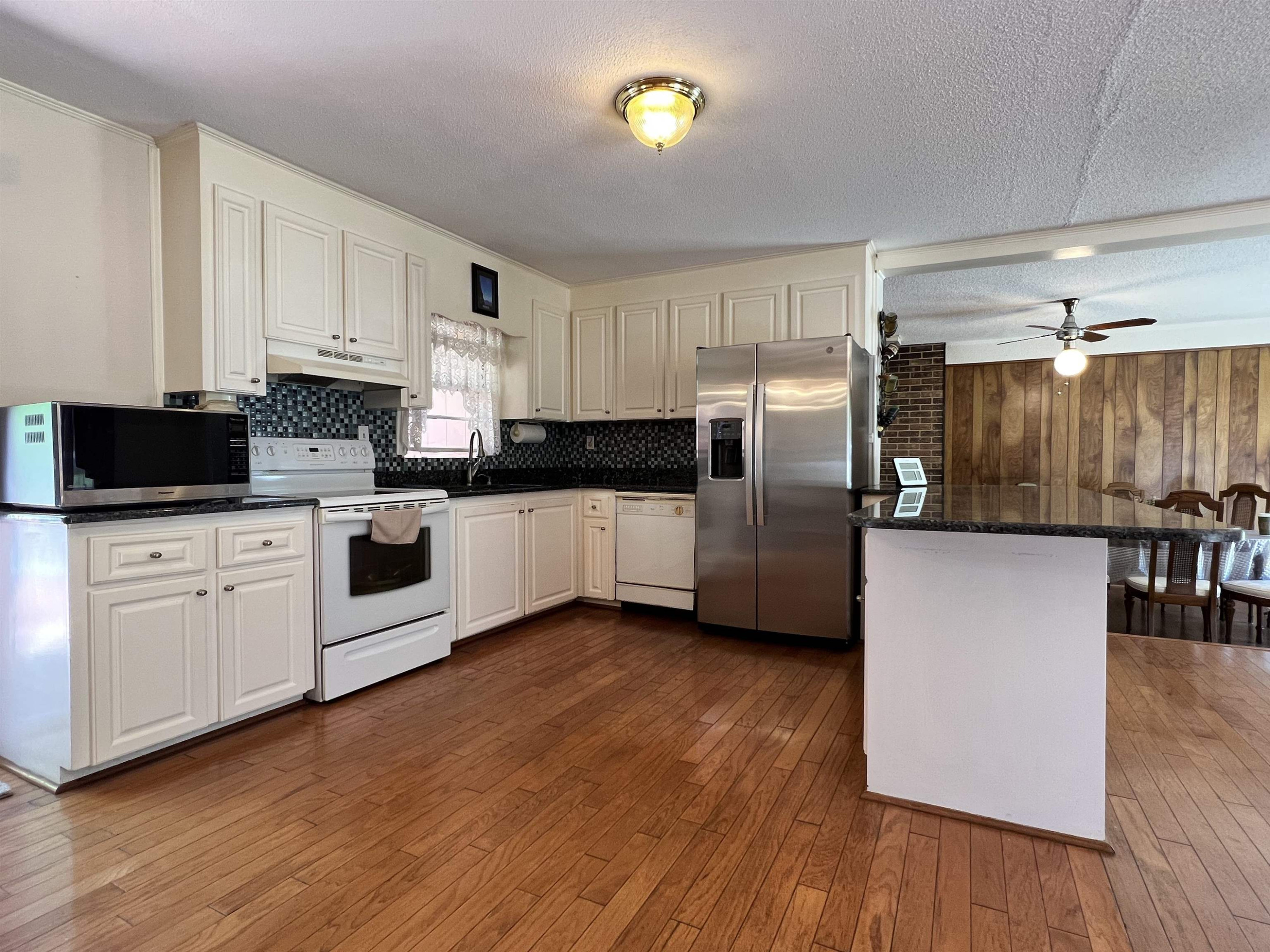 624 Woodland Road Raleigh, NC 27603 - Photo 12 of 29 a kitchen with stainless steel appliances a refrigerator sink and microwave