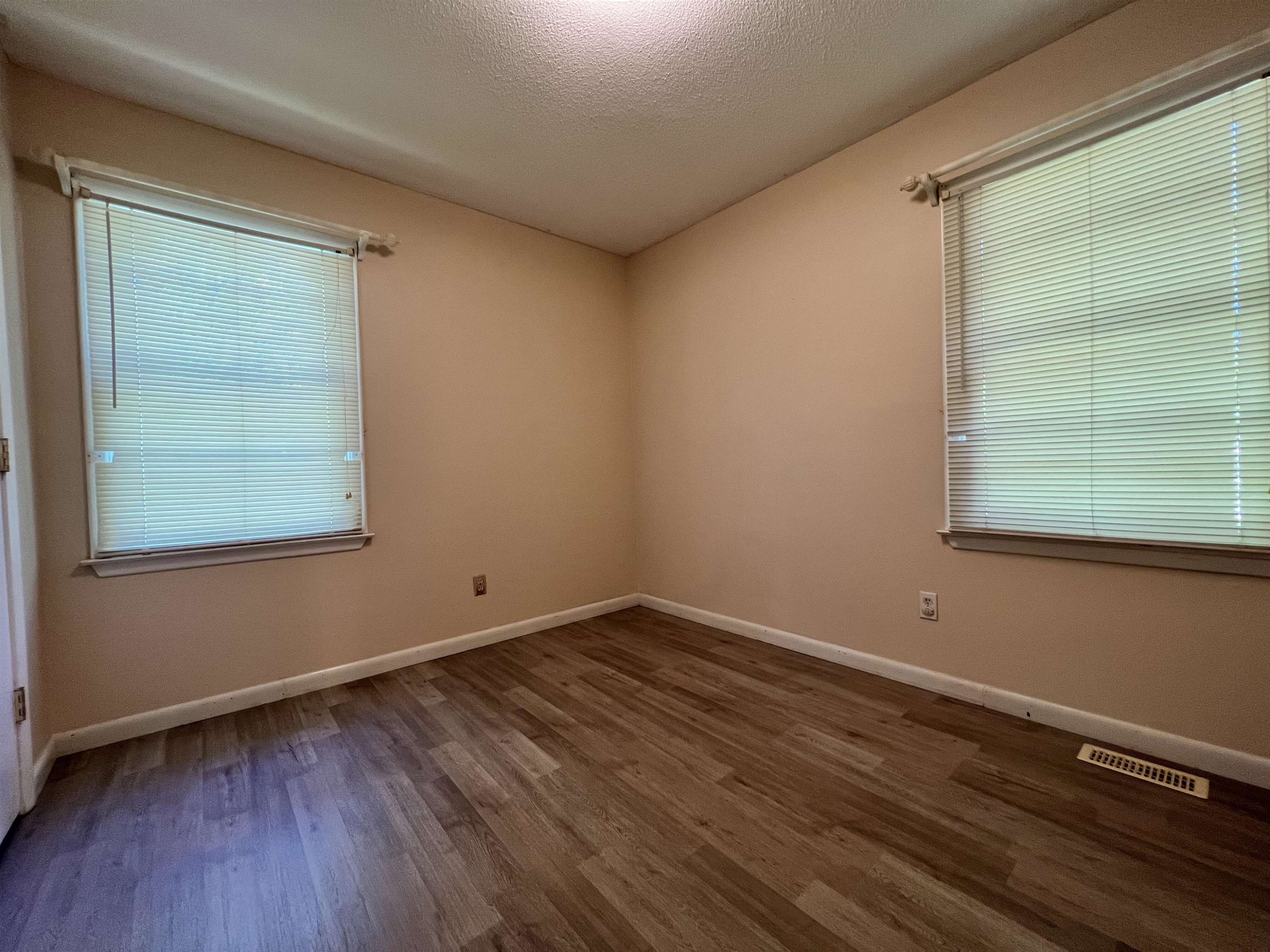 624 Woodland Road Raleigh, NC 27603 - Photo 19 of 29 an empty room with wooden floor and windows