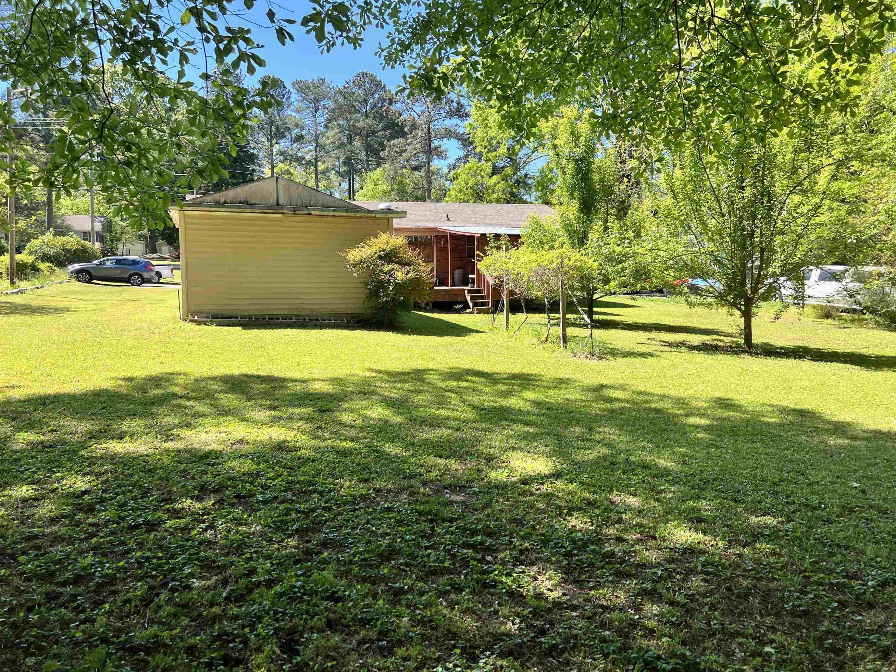 624 Woodland Road Raleigh, NC 27603 - Photo 26 of 29 a view of a house with a yard and a tree