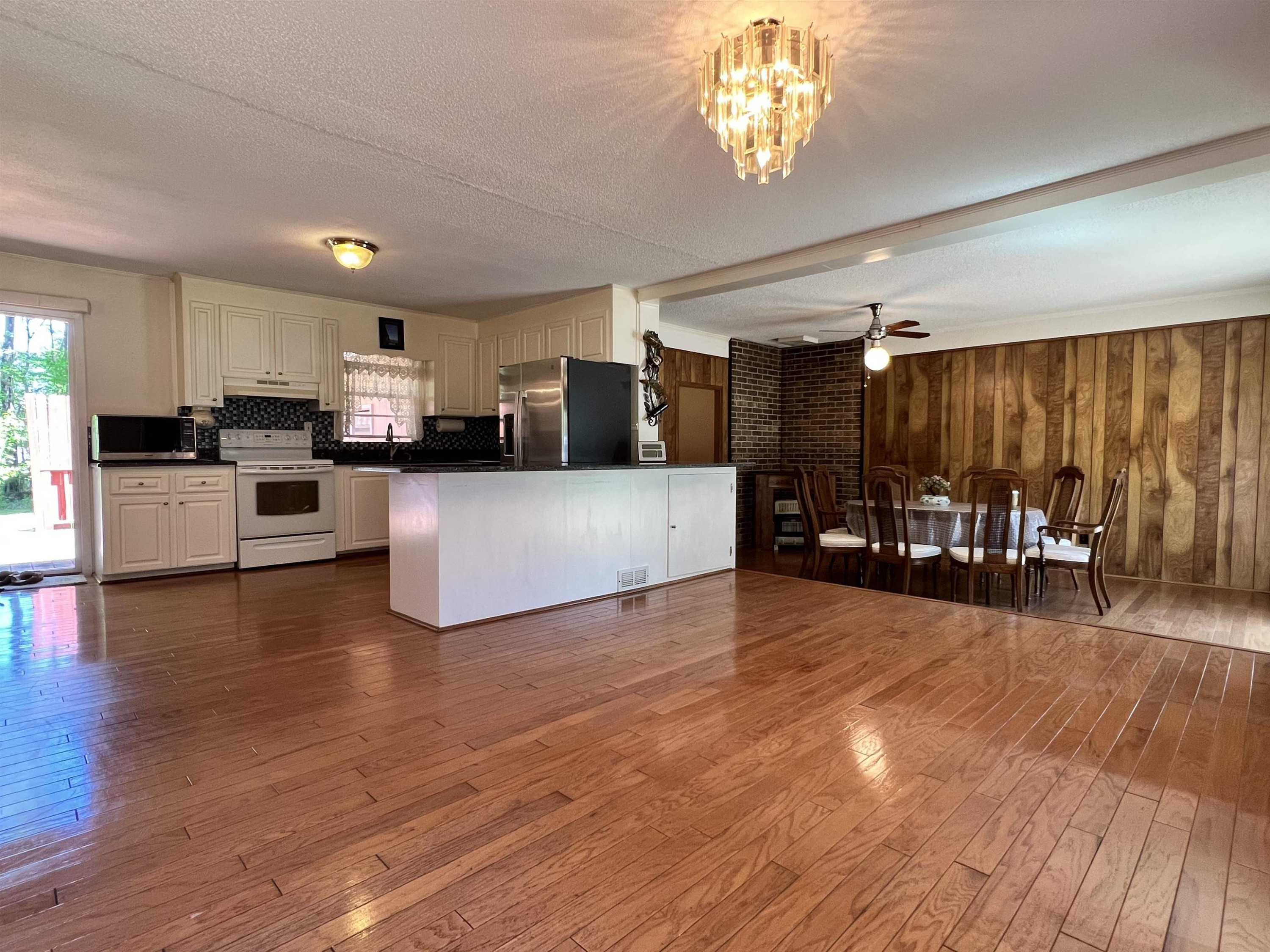 624 Woodland Road Raleigh, NC 27603 - Photo 3 of 29 a view of a kitchen with furniture and wooden floor