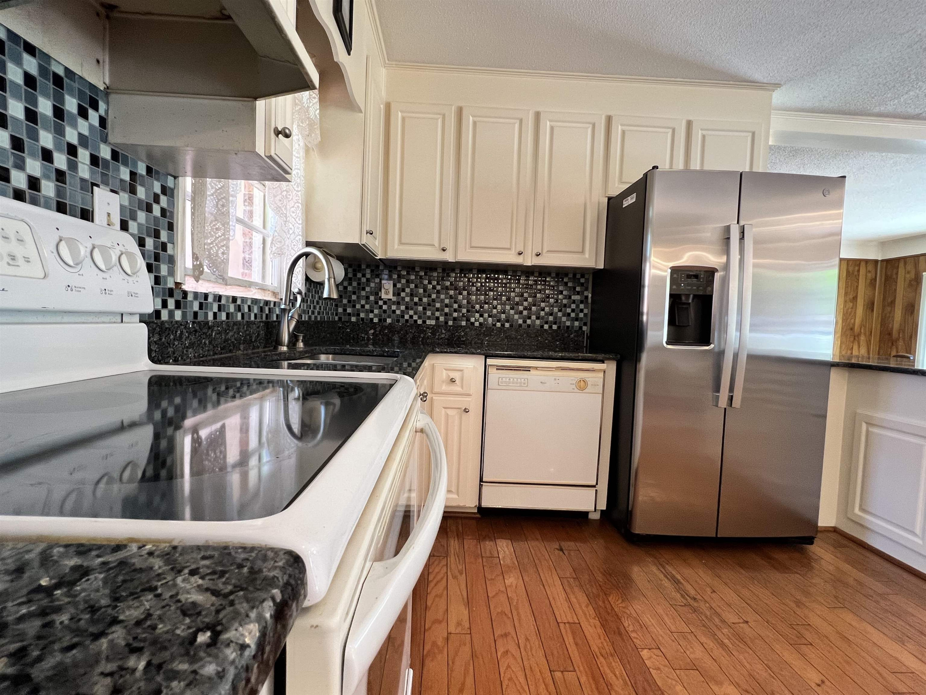 624 Woodland Road Raleigh, NC 27603 - Photo 10 of 29 a kitchen with a refrigerator sink and stove