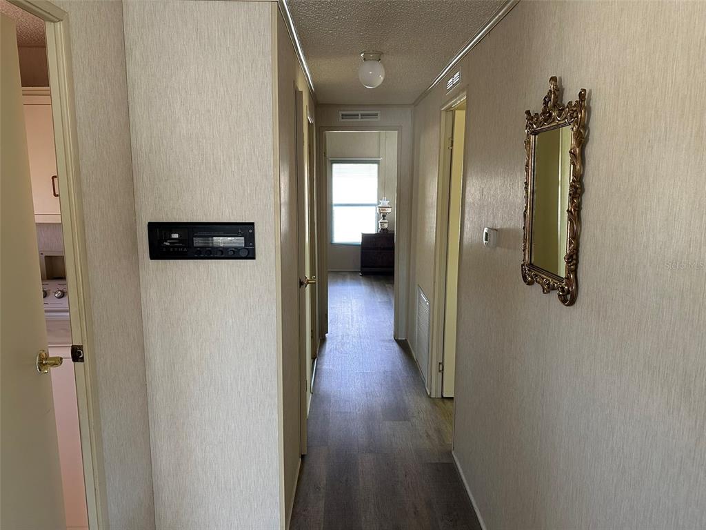 76 Eagle Circle Ellenton, FL 34222 - Photo 11 of 22 a view of a hallway with wooden floor