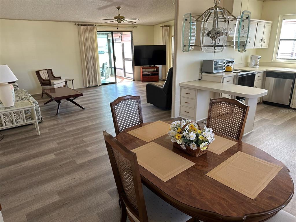 76 Eagle Circle Ellenton, FL 34222 - Photo 2 of 22 a living room with furniture kitchen view and a flat screen tv