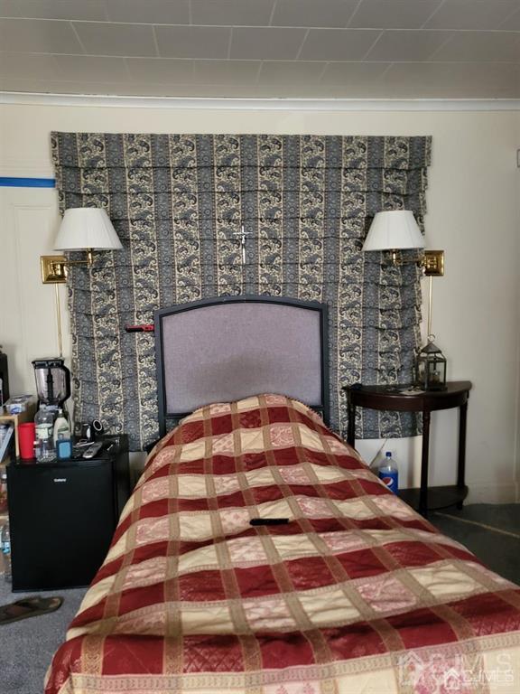 352 Front Street Dunellen, NJ 08812 - Photo 28 of 46 a bedroom with a bed and a table in it