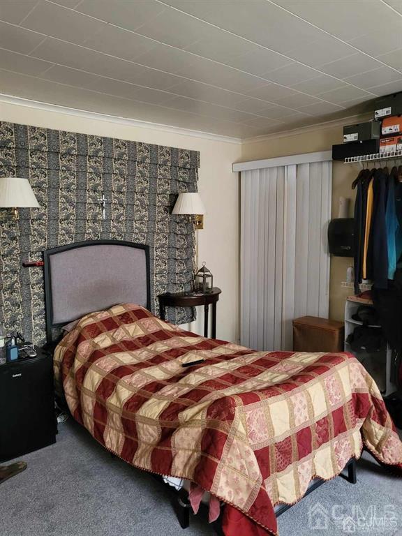 352 Front Street Dunellen, NJ 08812 - Photo 29 of 46 a bedroom with a bed and walk in closet