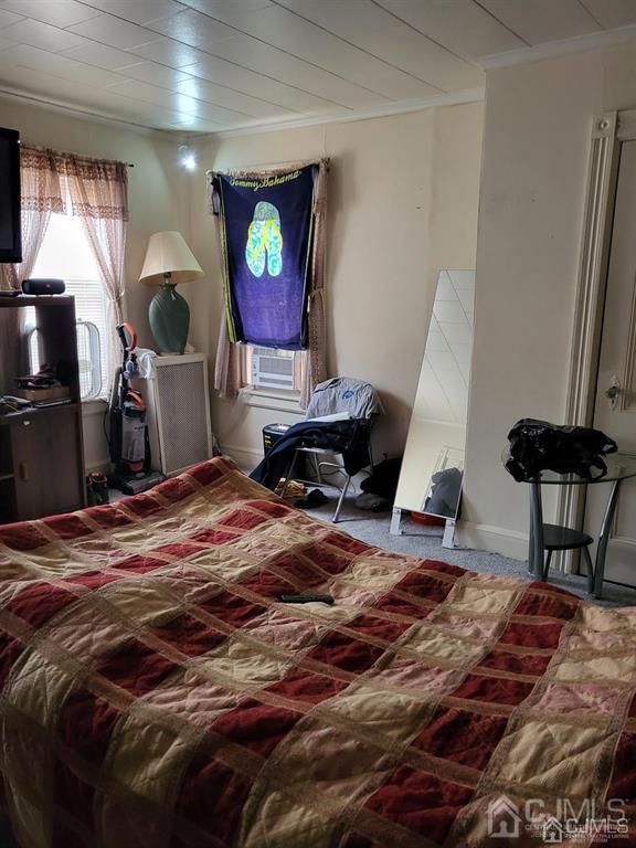 352 Front Street Dunellen, NJ 08812 - Photo 30 of 46 a bed sitting in a room next to a window