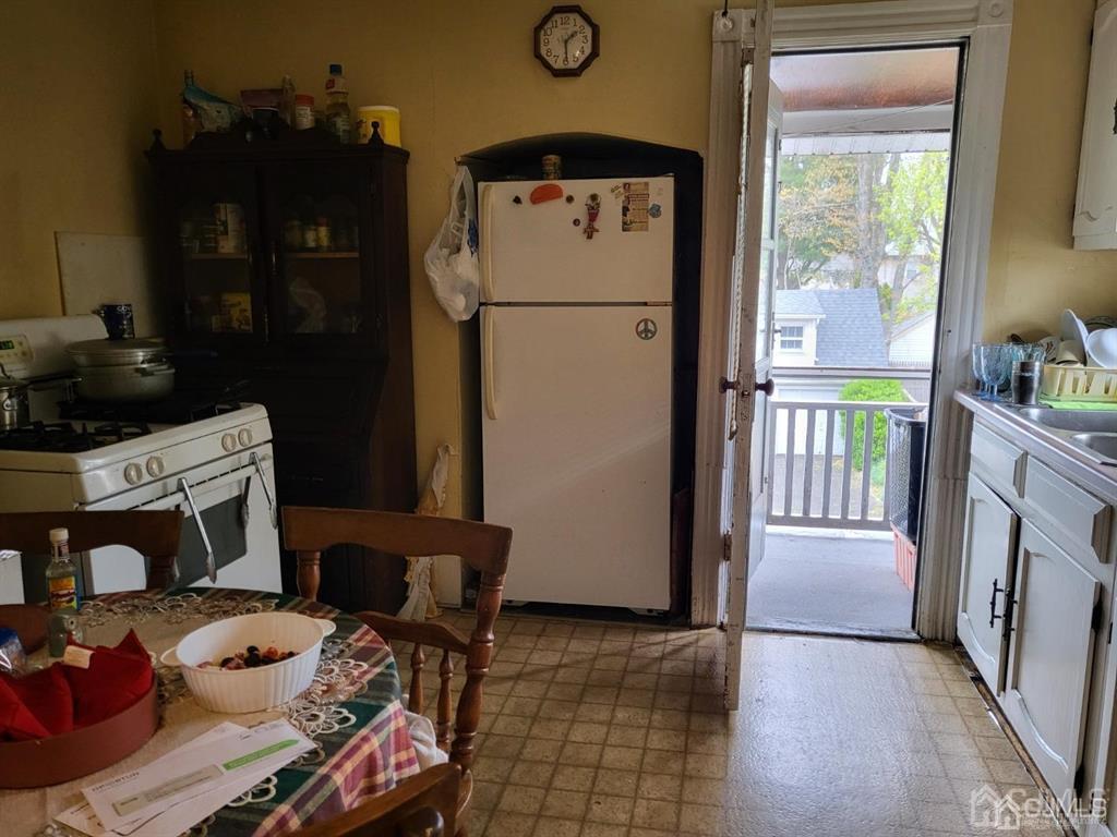 352 Front Street Dunellen, NJ 08812 - Photo 35 of 46 a kitchen with a refrigerator and a stove