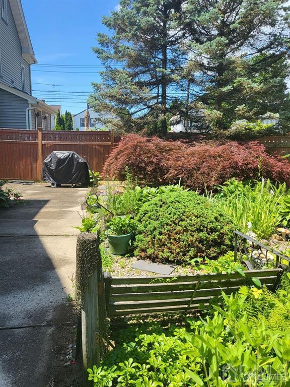 352 Front Street Dunellen, NJ 08812 - Photo 8 of 46 a view of a garden with a bench