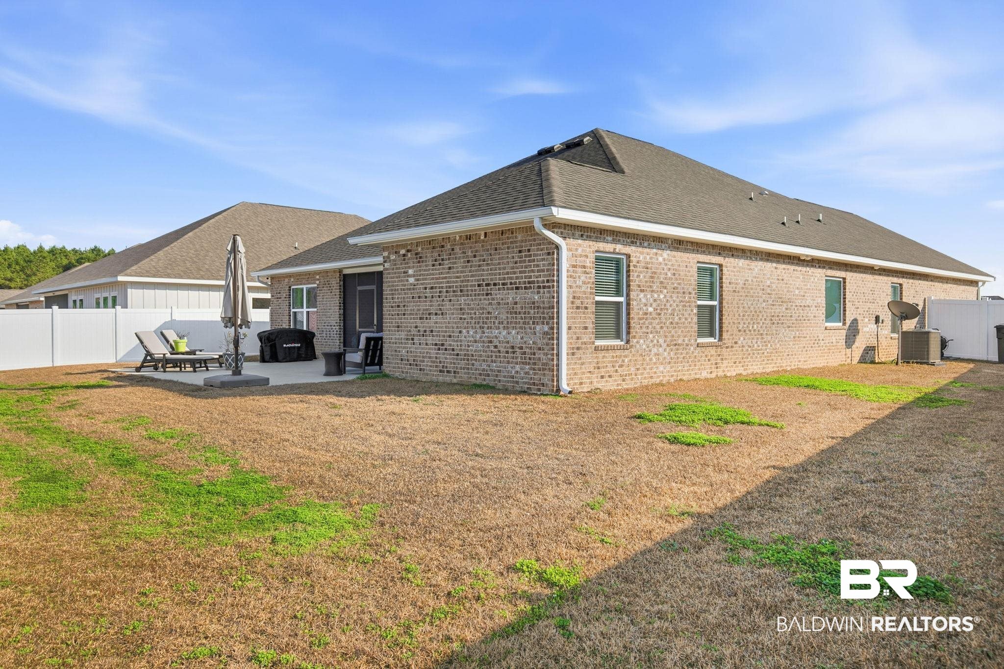 11123 Genuine Risk Circle Daphne, AL 36526 - Photo 49 of 67 View of home's exterior featuring a patio, brick siding, and a shingled roof