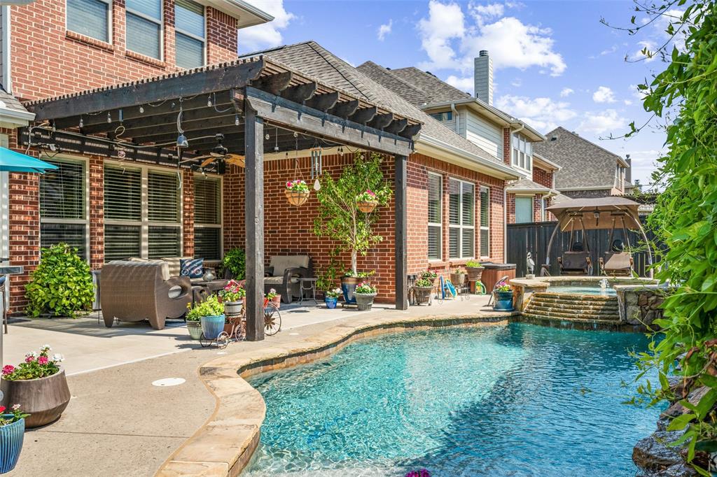 a view of a house with backyard sitting area and garden