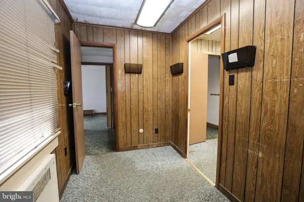 a view of a hallway with wooden cabinets