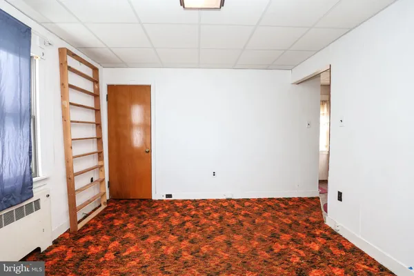 a room with a sink and a refrigerator