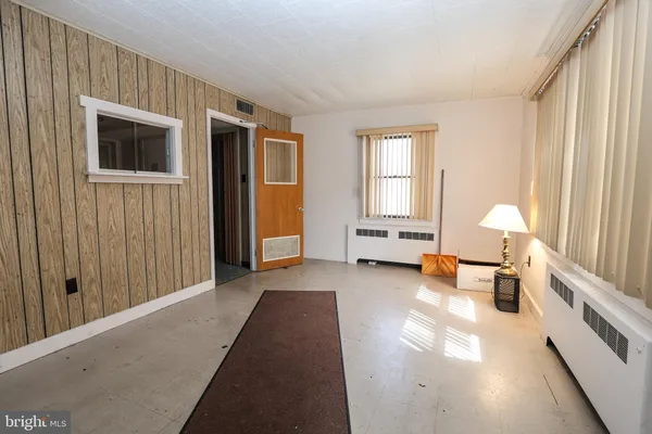 a hallway with a couch and a window