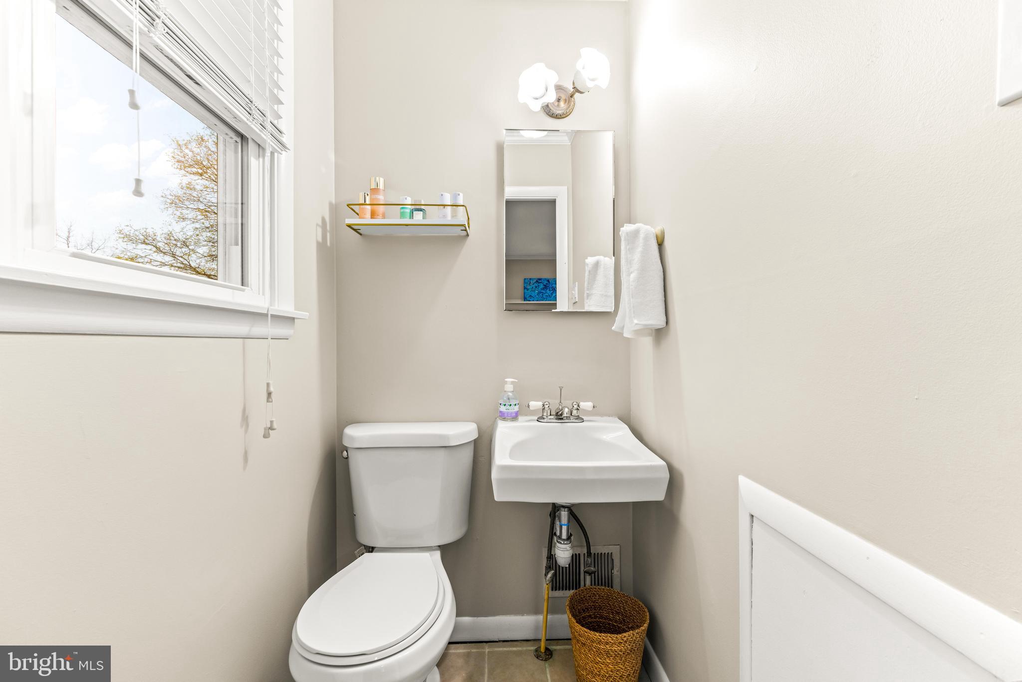1205 Mill Creek Road Fallston, MD 21047 - Photo 31 of 53 a bathroom with a toilet a sink and a mirror