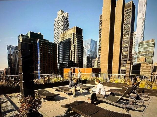 150 West 51st Street, Unit 1032 Manhattan, NY 10019 - Photo 13 of 19 a living room with furniture and large windows