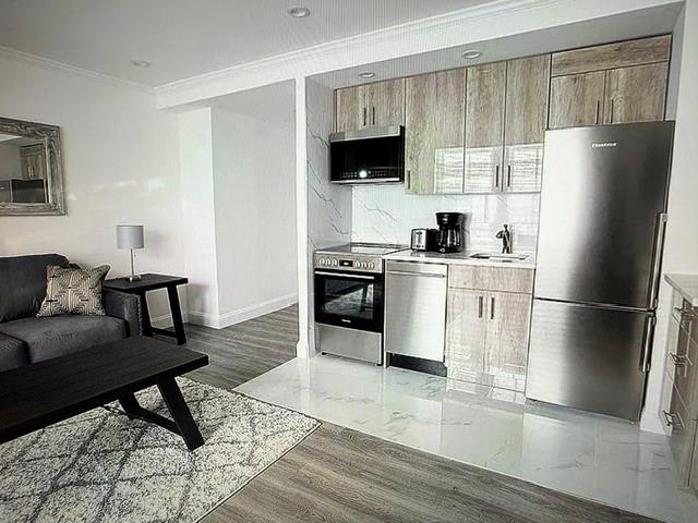 150 West 51st Street, Unit 1032 Manhattan, NY 10019 - Photo 2 of 19 a kitchen with stainless steel appliances granite countertop a refrigerator stove top oven and sink