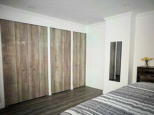 150 West 51st Street, Unit 1032 Manhattan, NY 10019 - Photo 7 of 19 a view of a bedroom with wooden floor and closet
