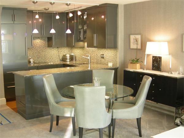 a kitchen with a dining table chairs and sink