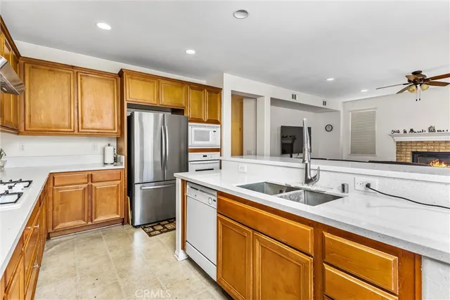 a kitchen with stainless steel appliances granite countertop a sink and a refrigerator