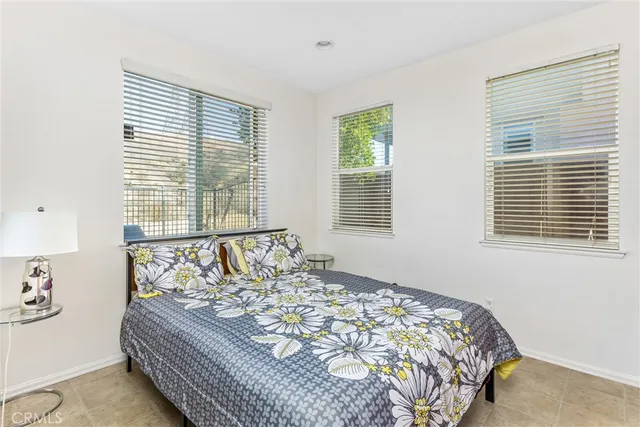 a bed sitting in a bedroom next to a window