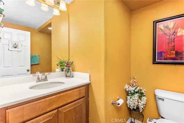 a bathroom with a sink mirror and toilet