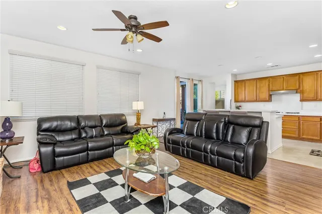 a living room with furniture and kitchen view
