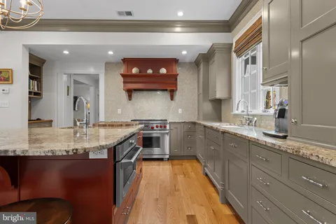 a view of a dining room with furniture a chandelier and wooden floor