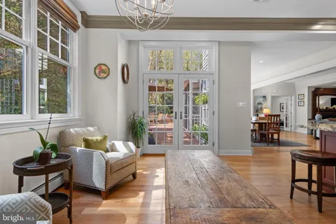 a living room with furniture wooden floor and a large window