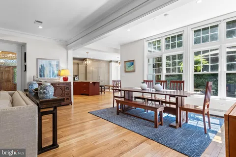 a living room with furniture wooden floor and a large window