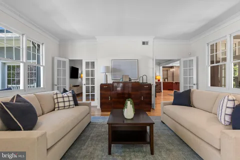 a view of a hallway with wooden floor and dining room
