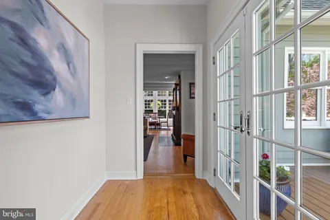 a view of entryway and hall with wooden floor