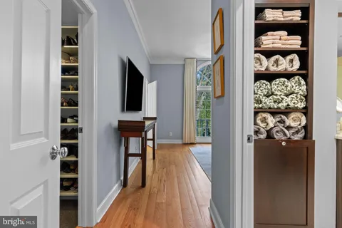 a bedroom with a bed lamp and a large window