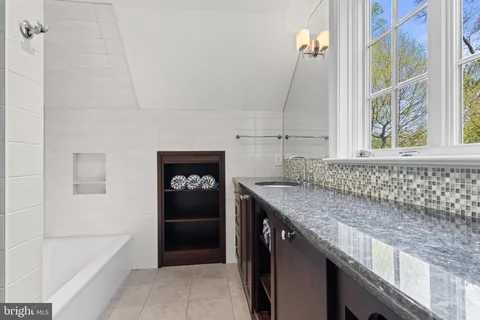 an aerial view of a house with a yard swimming pool and outdoor seating