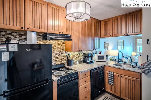 a bathroom with a granite countertop toilet sink and mirror