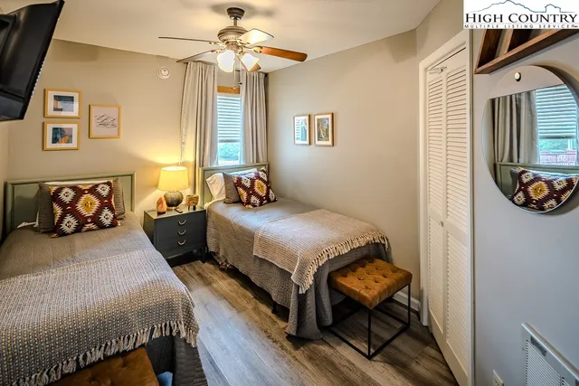 a bedroom with a bed and a painting on the wall