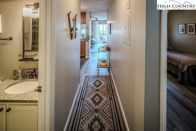 a kitchen with stainless steel appliances lots of white cabinets a swimming pool and stove