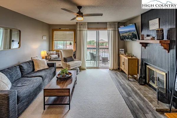 a living room with furniture and a fireplace