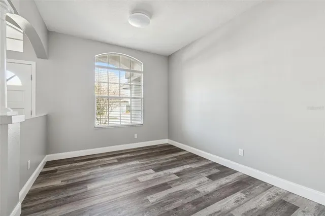a view of a room with wooden floor