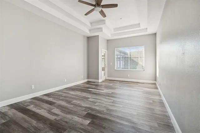 a kitchen with stainless steel appliances granite countertop a stove top oven a sink and white cabinets